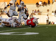 Galveston Ball Dominates Manvel High School in Season Opener at Freedom Field Player jumps over pile, Manvel, Galveston Ball, Football, Varsity Football