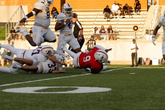 Galveston Ball Dominates Manvel High School in Season Opener at Freedom Field Player jumps over pile, Manvel, Galveston Ball, Football, Varsity Football