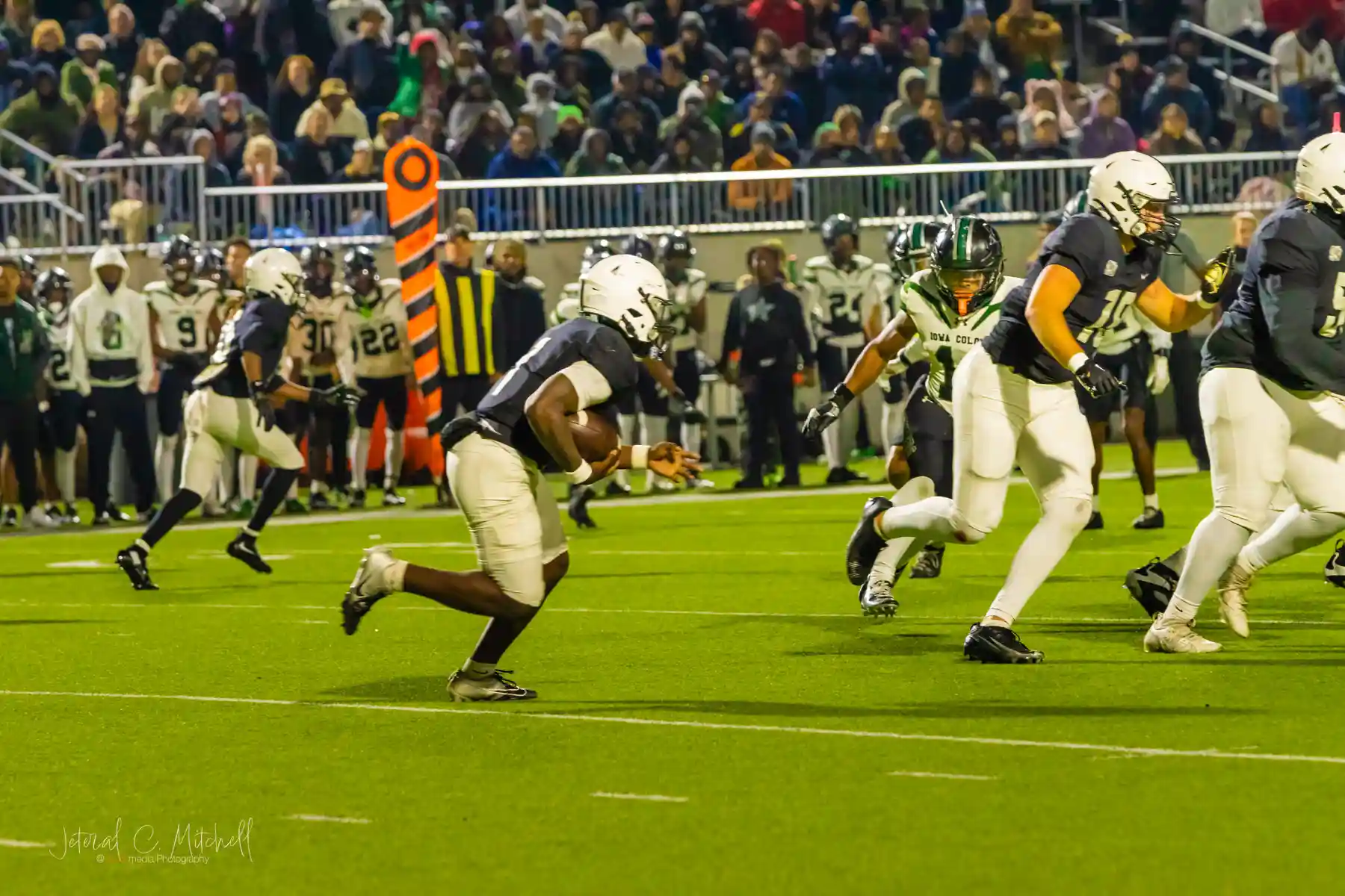 Landon Williams-Callis holding the ball in the backfield, preparing to take off behind the line of scrimmage during the 2025 UIL Regional Championship – Photo by JCurtisMedia | GamedaySportsJournal