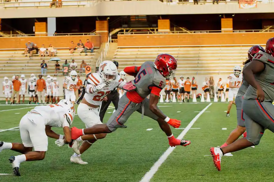 Manvel ball carrier fights through Alvin defenders