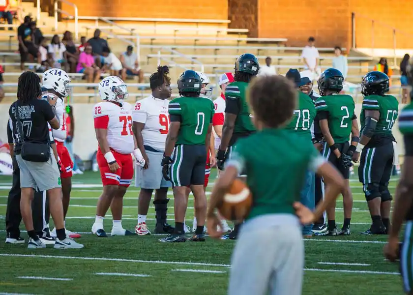 Manvel and Iowa Colony players meet on the field at Freedom Field