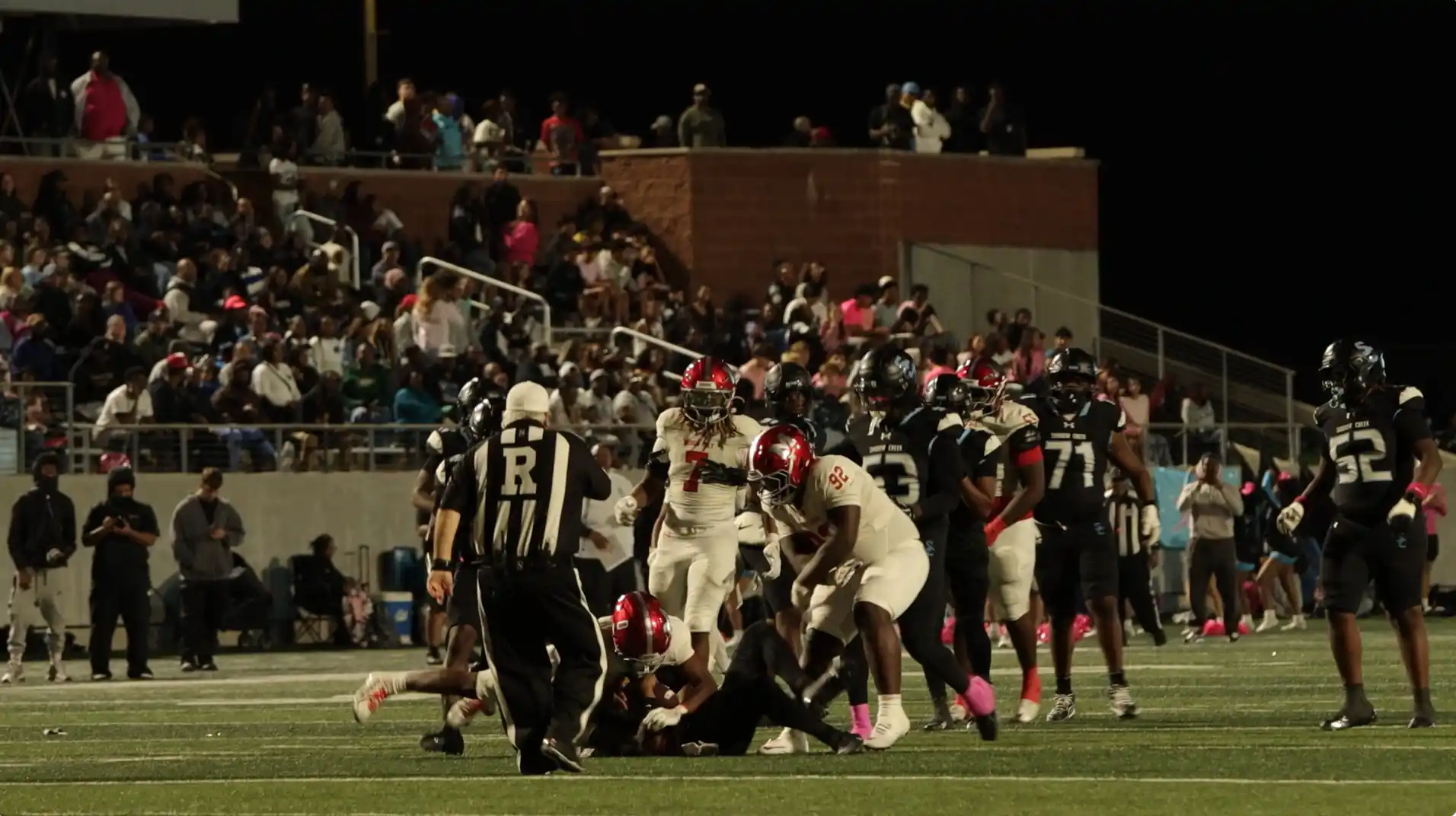 Manvel defender S. Weary number 0 pressuring Shadow Creek quarterback T. Coleman.