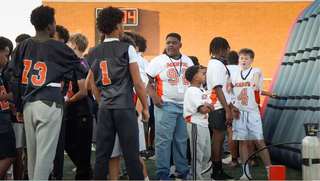 Young Manvel football players gathering near the tunnel